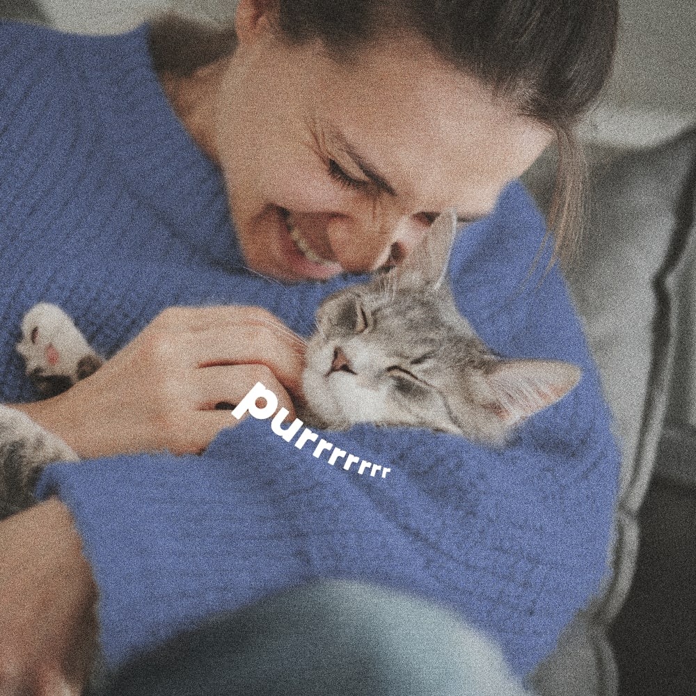 Woman smiling hugging cat